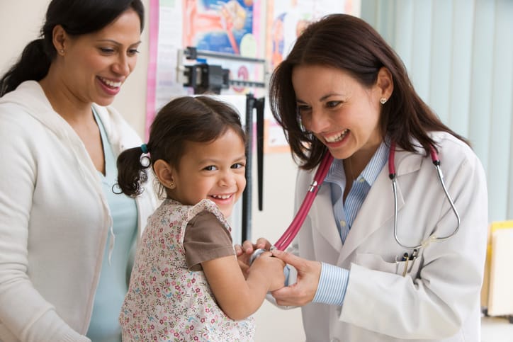 A child smiles in a clinic setting