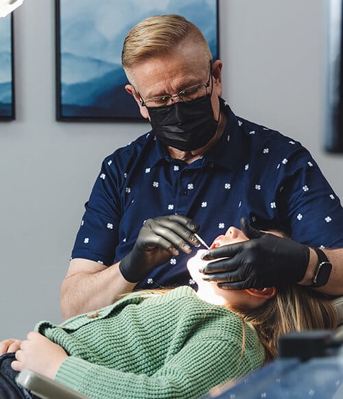 Layton orthodontist, David Hunter performs an exam