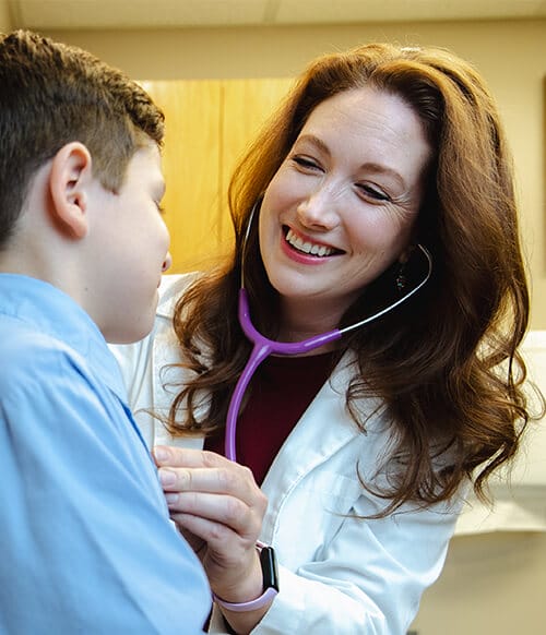 Provider portrait Colton Ragsdale, M.D. smiling with a young patient