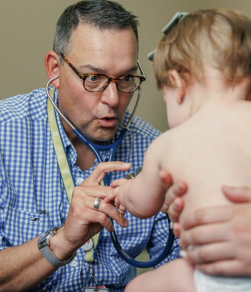 Peter Silas, M.D. interacts with a young patient