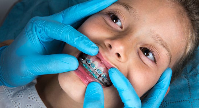 Girl getting their braces examined