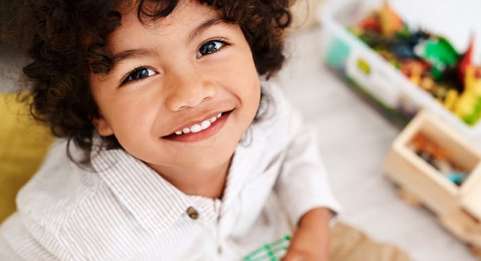 kid beaming a shiny smile