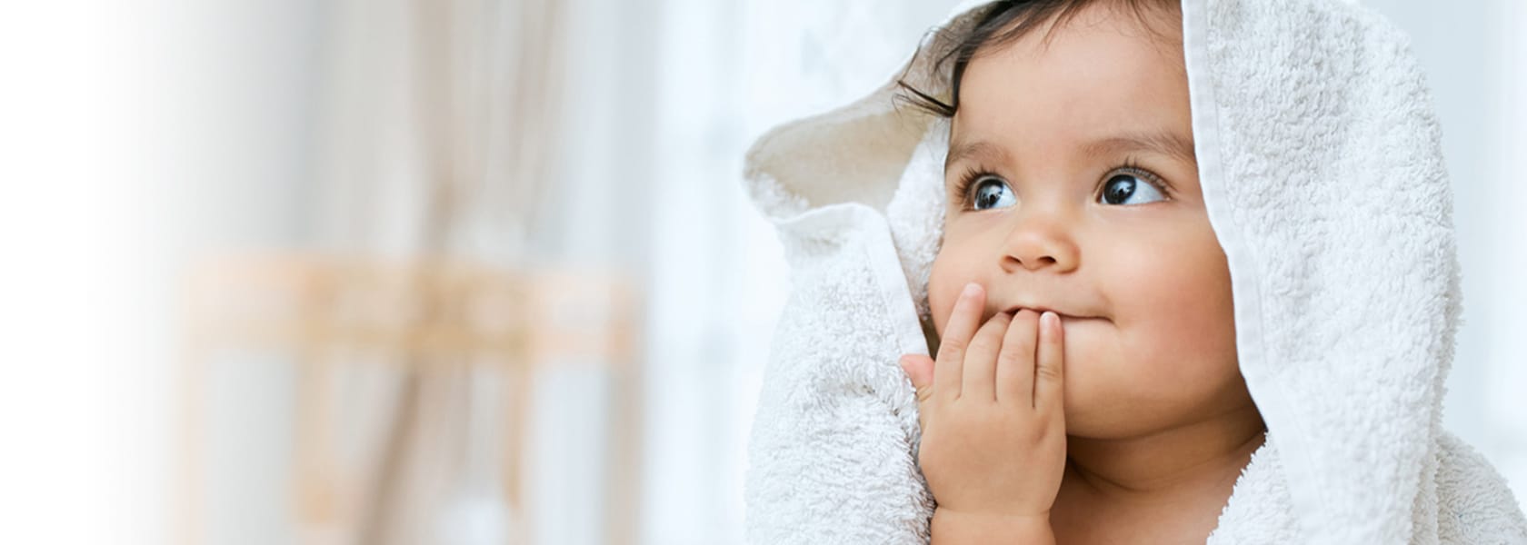 happy baby wearing a bath towel