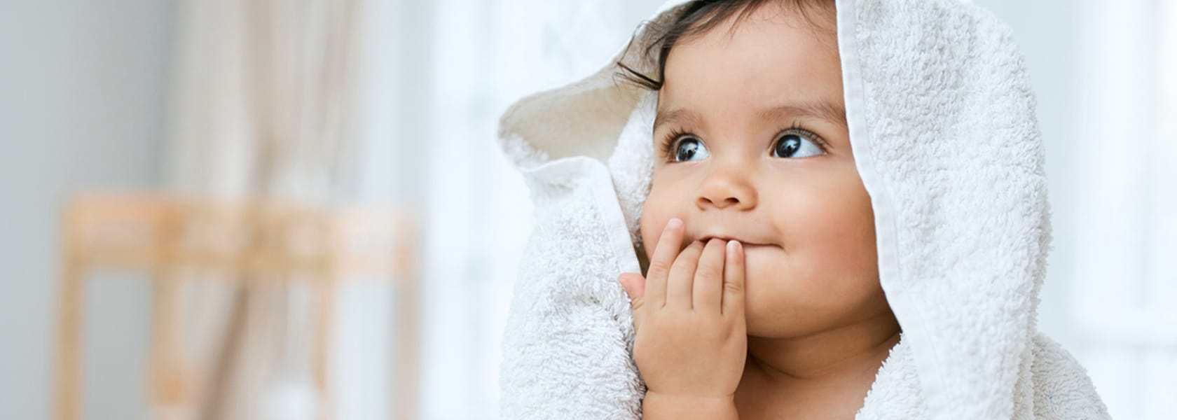happy baby wearing a bath towel