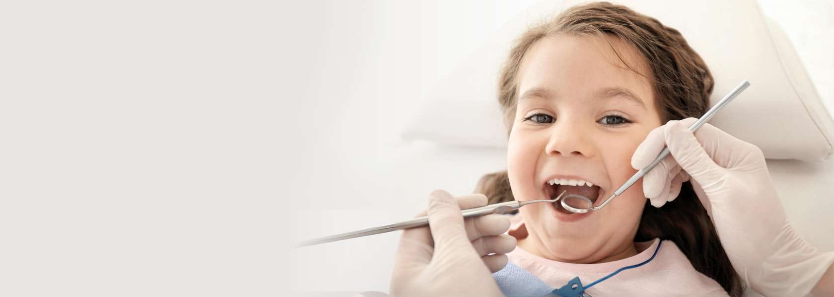 Toddler girl smiling at the dentist office