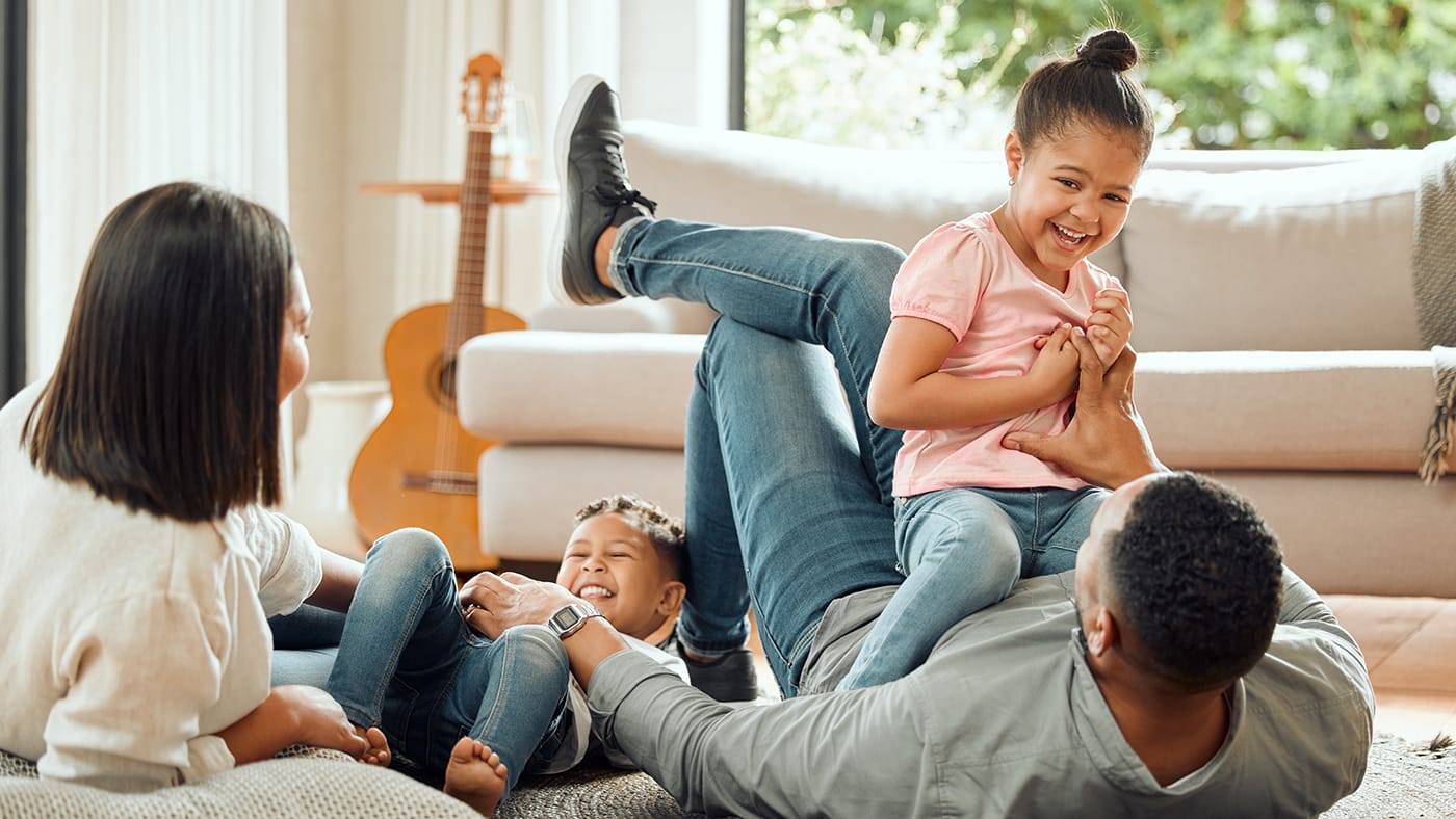 family playing together on the floor in the living room