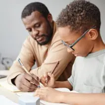 A child doing homework with their parent