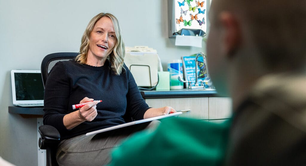 Smiling counselor with young patient