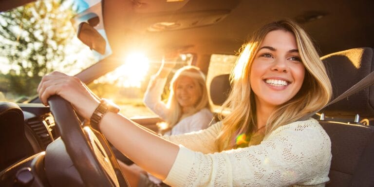 Smiling teen driving her car