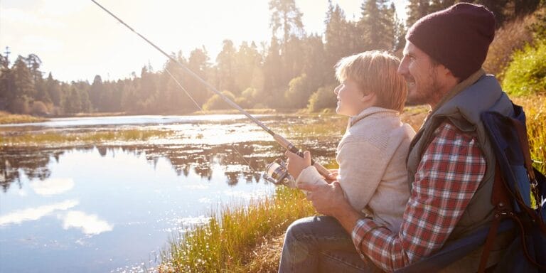 Father and son fishing at a mountain lake