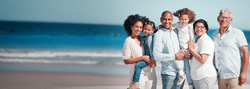 A happy family smiles on the beach
