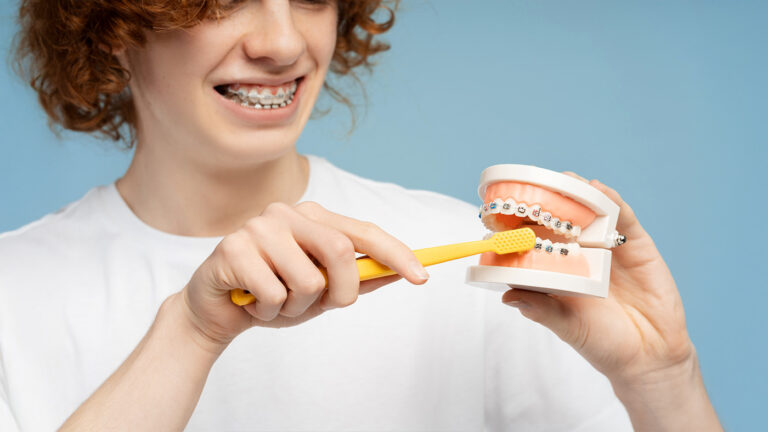 Young boy with braces learning how to brush
