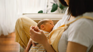 Newborn baby breastfeeding from its mother