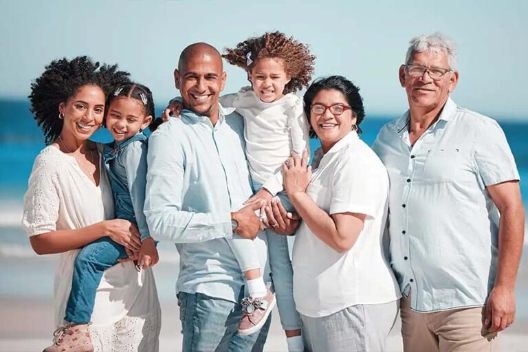Multigenerational family smiling on the beach