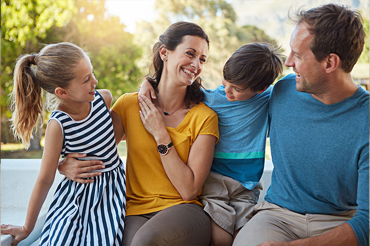 Smiling father and mother with their children