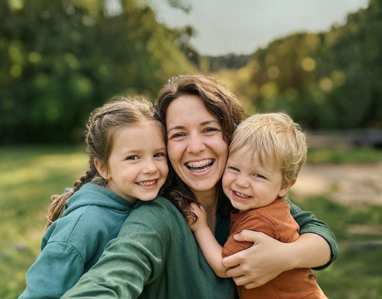 Smiling mom with her son and daughter