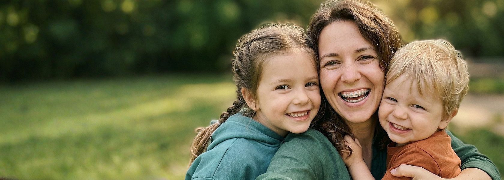 Smiling mom with her son and daughter