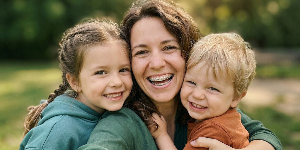 Smiling mom with her son and daughter
