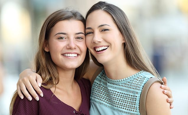 Teen girls smile at the camera